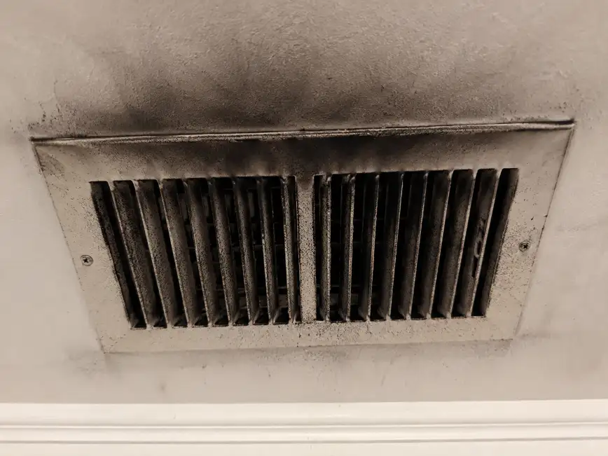 Professional inspection of a fire-damaged HVAC furnace
